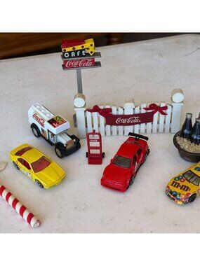 Mixed Lot of 9 Coca-Cola/M&Ms/North Pole Mini Collectible Toys (Various Sizes)